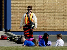 A school employee watches over some students at Waverley Elementary School in Edmonton on Friday September 18, 2020. File photo.