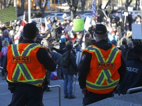 Hundreds came out during the anti-mask Walk for Freedom as police kept an eye on them at City Hall in Calgary on Saturday, December 5, 2020.