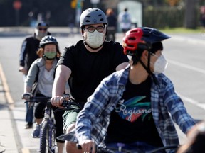 Masked cyclists are seen in Golden Gate Park ahead of the new stay-at-home order in attempts to stem coronavirus spikes in San Francisco, Sunday, Dec. 6, 2020.