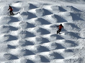 A couple of skiers try their luck on the moguls as the sunlight creates a nice visual pattern effect at Snow Valley Ski Club in Edmonton, March 2, 2020.