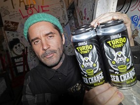 Jay Sparrow at Sea Change Brewery in Edmonton with some cans of their popular Turbo Stout beer, brewed in collaboration with Farrow Sandwiches.