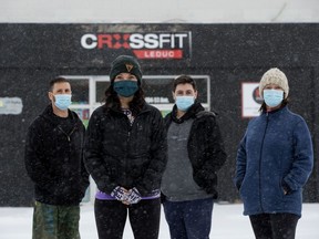 (left to right) CrossFit Leduc co-owner Brad Bendfeld, co-owner Andrea Bendfeld, coach Donovan Bendfeld, and cleaning support personnel Shirley Giesbrecht (Andrea Bendfeld's mother) pose for a photo outside the business, in Leduc Saturday Jan. 23, 2021. The owners say the business is at risk of shutting down because of COVID-19 restrictions. They have started doing zoom workouts to continue operating and one of their clients has raised thousands of dollars of to help pay the rent.