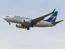 A Westjet Boeing 737-700 aircraft lands at Edmonton International Airport.