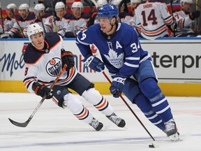 Kyle Turris #8 of the Edmonton Oilers skates to check Auston Matthews #34 of the Toronto Maple Leafs during an NHL game at Scotiabank Arena on January 20, 2021 in Toronto.