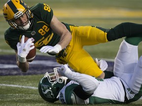 Edmonton Eskimos receiver Greg Ellingson (82) is tackled by the Saskatchewan Roughriders' L.J. McCray (21) at Commonwealth Stadium in this file photo from Oct. 26, 2019.