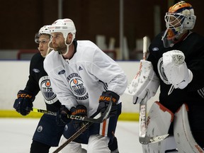 Caleb Jones, left, Zack Kassian and goaltender Anton Forsberg take part in Day 2 of the Edmonton Oilers 2020-2021 training camp at the Northern Alberta Institute of Technology in Edmonton Monday Jan. 4, 2021.