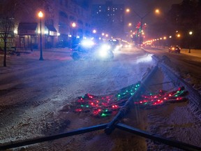 A Saskatoon police vehicle blocks a road near a fallen lamp post on 25th Street on Jan. 13.