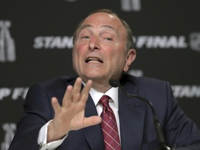 In this May 27, 2019, file photo, NHL commissioner Gary Bettman speaks to the media before Game 1 of the NHL hockey Stanley Cup Finals between the St. Louis Blues and the Boston Bruins, in Boston.