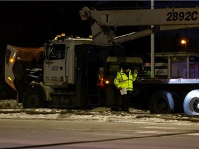 Edmonton Police Service officers investigate a fatal collision involving a crane truck and a bicycle at 94B Avenue and 50 Street in Edmonton, on Monday, Jan. 4, 2021.