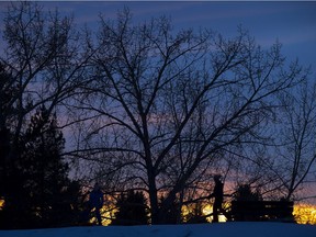Tobogganers take advantage of the last bit of sunlight on a hill near the Ottewell community league on Monday, Jan. 11, 2021 in Edmonton.
