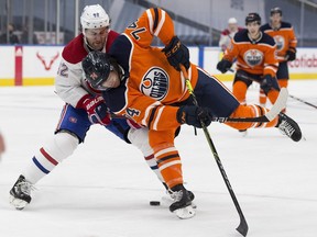 Edmonton Oilers Ethan Bear (74) and Montreal Canadiens Jonathan Drouin (92) battle for the puck during second period NHL action on Saturday, Jan. 16, 2021 in Edmonton.