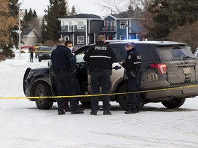 Police investigate the scene where a man was rushed to hospital in life-threatening condition after a shooting in west Edmonton on Sunday, Jan. 17, 2021 in Edmonton.  Police were called to a home near 105 Avenue and 157 Street around 6:15 a.m.