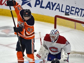 Edmonton Oilers Ryan Nugent-Hopkins (93) deflects the puck toward Montreal Canadiens Jake Allen (34) during NHL action at Rogers Place in Edmonton, January 18, 2021.