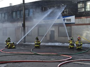 Firefighters battling a fire at a boarded up commercial building on 116 Street at 106 Avenue in Edmonton on Wednesday, Jan. 20, 2021.