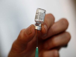 A health-care professional prepares a needle with the COVID-19 vaccine from Pfizer-BioNTech at a vaccination centre in Paris, France, on Jan. 18, 2021.
