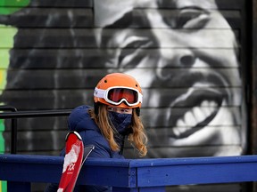 A girl takes a break on the clubhouse deck at the Edmonton Ski Club on Sunday January 3, 2021. (Photo by Larry Wong/Postmedia)