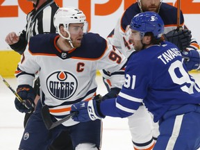 Toronto Maple Leafs captain John Tavares (91) and Edmonton Oilers captain Connor McDavid (97) take a face off in Toronto on Friday Jan. 22, 2021.