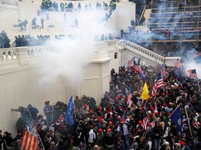 Police release tear gas into a crowd of pro-Trump protesters during clashes at a rally to contest the certification of the 2020 U.S. presidential election results by the U.S. Congress, at the U.S. Capitol Building in Washington, U.S, January 6, 2021.