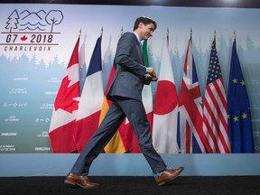 Canadian Prime Minister Justin Trudeau leaves following the final press conference at the conclusion of the G7 summit in La Malbaie, Quebec, June 9, 2018.  Trudeau confirmed he had warned Donald Trump his country would impose retaliatory tariffs on US goods from July 1, denouncing Trump's decision to invoke national security concerns to impose tariffs on aluminum and steel as "insulting" to the Canadian war veterans who had fought alongside US allies.