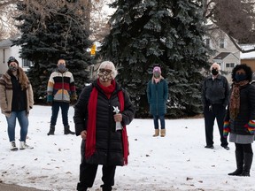 Supporters of a project, including 2020 Stars of Alberta Volunteer Award winner Kathy King, centre, to turn an unnamed park near 90 Avenue and 120 Street into a memorial for missing and murdered Indigenous women and girls join together for a photo in Edmonton on Dec. 31, 2020.