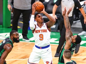 RJ Barrett of the New York Knicks shoots the ball over Jeff Teague of the Boston Celtics during a game at TD Garden on January 17, 2021 in Boston.