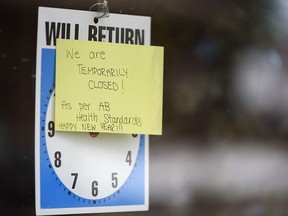 A sign behind the window of a closed store in Kensington on Wednesday, Jan. 6, 2021.