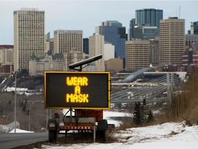 A sign flashes messages about COVID-19 restrictions, in Edmonton Wednesday Jan. 6, 2021.