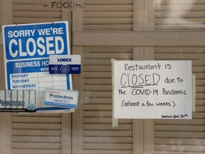 A sign in the front window informs patrons that the Wokkery Restaurant, 10969 98 St., has temporarily closed due to COVID-19, in Edmonton Thursday Dec. 24, 2020. File photo.