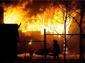 Fire crews battle a blaze near 71 Street and 70 Avenue, in Edmonton, Monday Jan. 11, 2021.