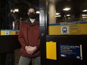 Outbreaker Solutions co-founder Matt Hodgson on Thursday, Jan. 21, 2021, stands beside his company's yellow germ killing push-plates that have been installed on doors at 10 Edmonton transit stations.