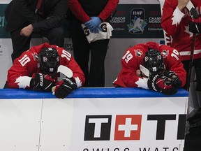 Dejected members of team Canada sit on the bench after being defeated by the United States in the IIHF world junior championship gold-medal game on Tuesday, Jan. 5, 2021, in Edmonton.