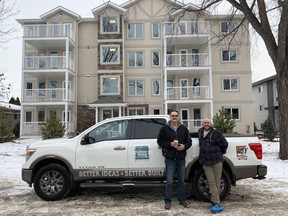 Dave Hinteregger and Darrell Burak of Concept Homes celebrate the completion of the affordable housing building for Right At Home Housing Society.