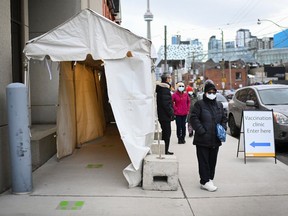 Front line healthcare workers wait in line to receive the Pfizer-BioNTech COVID-19 mRNA vaccine during the COVID-19 pandemic in Toronto on Tuesday, December 15, 2020.