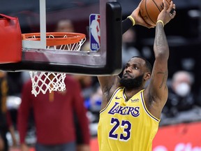 Los Angeles Lakers star LeBron James dunks in the fourth quarter against the Cleveland Cavaliers on Jan. 25, 2021.