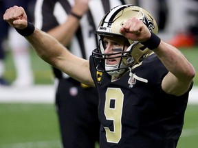 New Orleans Saints quarterback Drew Brees celebrates a touchdown by running back Alvin Kamara during their NFL wild-card playoff game on Jan. 10, 2021, against the Chicago Bears.