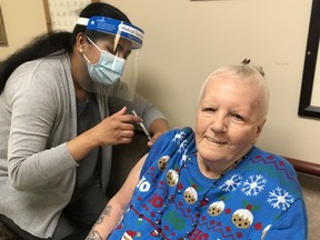 Sharon McGowan, 72, was one of the first Albertans in long-term care to receive the COVID-19 vaccine on Wednesday, Dec. 30, 2020. McGowan is a resident of Extendicare Holyrood in Edmonton. ALBERTA HEALTH SERVICES