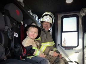 South Pigeon Lake Fire Chief Wayne Benson hangs out with his grandchild Brody Meaver. Benson was diagnosed with a rare form of cancer last year and required surgery in November. SUPPLIED