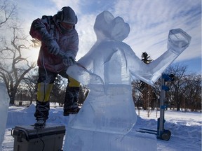 Kelly Davies working on a ice sculpture of a moose playing a violin on Borden Park for Deep Freeze.