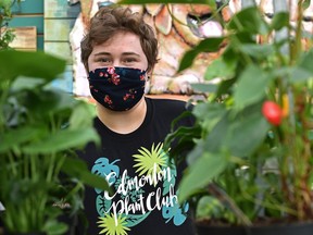 Spencer Gnida is the founder of the Edmonton Plant Club wearing the club's t-shirt created after a design competition from club members.