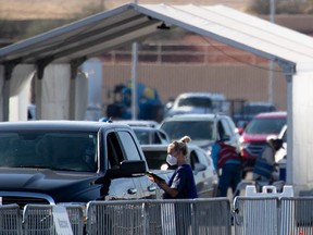 People wait after receiving the COVID-19 vaccination at State Farm Stadium on Feb. 11, 2021 in Glendale, Arizona. Maricopa County is in phase 1B of vaccine rollout, allowing law enforcement, adults age 75 and over and K-12 school staff and childcare workers to receive the vaccine.