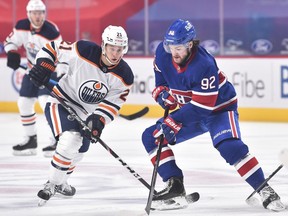 Dominik Kahun (No. 21) of the Edmonton Oilers skates against Jonathan Drouin (No. 92) of the Montreal Canadiens during the first period at the Bell Centre in Montreal on February 11, 2021.