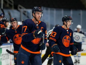 Connor McDavid #97 of the Edmonton Oilers celebrates an assist and his 500th career point on a goal against the Winnipeg Jets at Rogers Place on February 17, 2021.