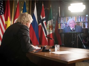 LONDON, ENGLAND - FEBRUARY 23: Prime Minister Boris Johnson watches a video address by Sir David Attenborough at a session of the UN Security Council on climate and security at the Foreign, Commonwealth and Development Office on February 23, 2021 in London, England. The United Kingdom holds the security council's rotating presidency and is the host nation of this year's COP26 UN climate summit in Glasgow.