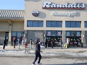 AUSTIN, TEXAS - FEBRUARY 19: A line of people wait for the Randall's grocery store to open as they look to purchase essentials on February 19, 2021 in Austin, Texas. Winter storm Uri brought historic cold weather and power outages to Texas.