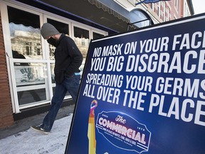 A pedestrian makes their way past the Commercial Hotel - Blues On Whyte Pub, 10329 82 Ave.,  Monday Feb. 8, 2021.