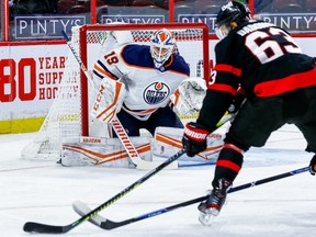 Edmonton Oilers goaltender Mikko Koskinen (19) readies to make a save against Ottawa Senators right wing Evgenii Dadonov (63) in first period NHL action at the Canadian Tire Centre.