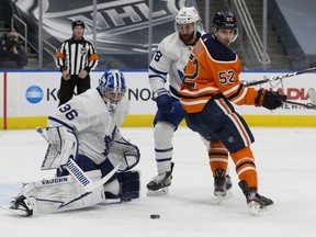 Toronto Maple Leafs' goalie Jack Campbell (36) makes a pad save as the Edmonton Oilers' Patrick Russell (52) battles T.J. Brodie (78) at Rogers Place in Edmonton on Saturday, Feb. 27, 2021. The Oilers lost 4-0.