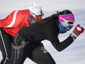 Two speed skaters do some laps at Victoria Park skating oval in Edmonton on Monday February 1, 2021.