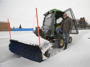 Rienk Mulder, with the Newton Community League, clears snow off the rink on Tuesday, Feb. 2, 2021.  The city recently donated snow-clearing machines to three community leagues.