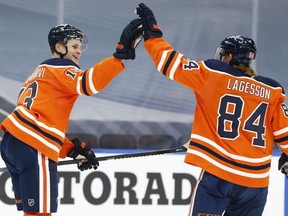 Edmonton Oilers forward Jesse Puljujarvi (13) celebrates a goal with William Lagesson (84) during first period NHL action at Rogers Place in Edmonton, on Tuesday, Feb. 2, 2021.